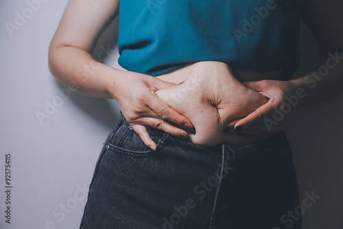 fat woman, fat belly, chubby, obese woman hand holding excessive belly fat with measure tape, woman diet lifestyle concept