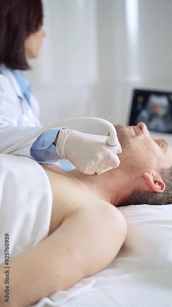 Doctor woman with white medical gloves performing neck ultrasound exam on male patient Doctor woman with white medical gloves performing neck ultrasound exam on male patient