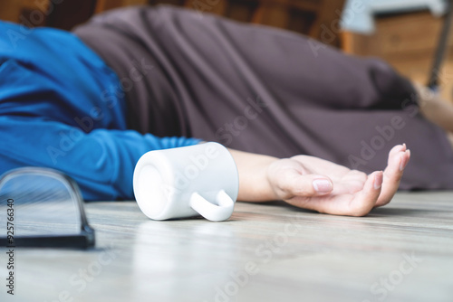 woman accident fainting and falling on the floor caused by syncope , hypotension or heart condition concept photo