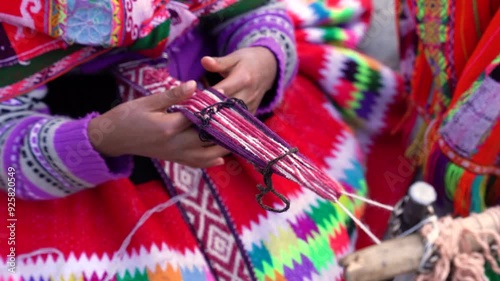 hands of peruvian woman weaving in Cusco Perú with traditional costume
