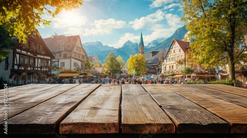 empty wooden table with blurred bavarian oktoberfest on open air background