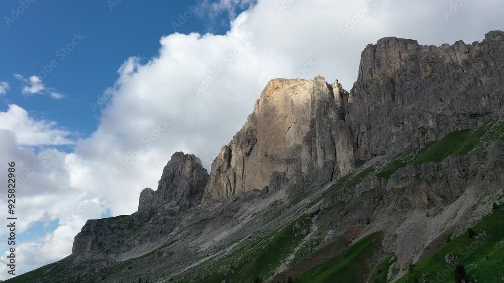 Aerial view of Dolomites mountain peaks shrouded in clouds on a sunny day, South Tyrol, Italy Aerial view of Dolomites mountain peaks shrouded in clouds on a sunny day, South Tyrol, Italy