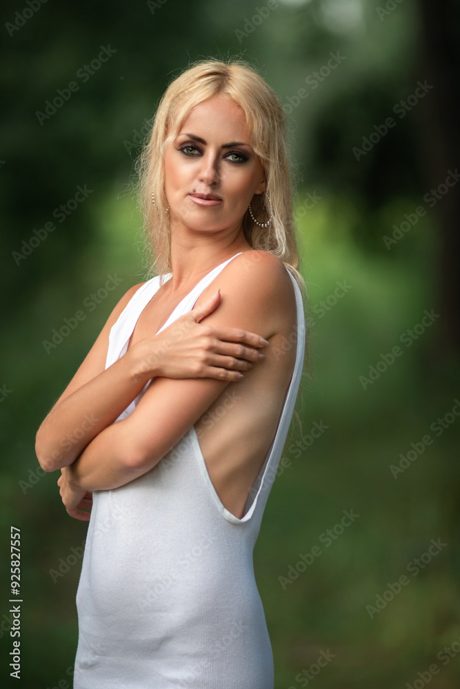 Portrait of a young beautiful blonde green-eyed girl in nature. Portrait of a young beautiful blonde green-eyed girl in nature.
