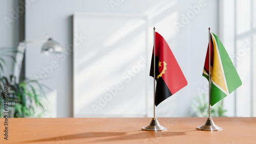 FLAGS OF ANGOLA AND GUYANA  ON TABLE photo