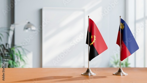 FLAGS OF ANGOLA AND LIECHTENSTEIN  ON TABLE photo