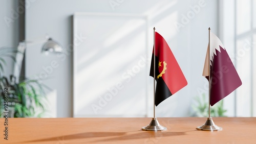 FLAGS OF ANGOLA AND QATAR  ON TABLE photo