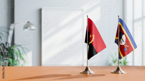 FLAGS OF ANGOLA AND SWAZILAND  ON TABLE photo