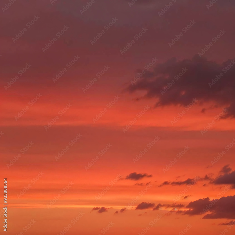 Fiery sunset with vivid red and orange clouds over distant mountains Fiery sunset with vivid red and orange clouds over distant mountains
