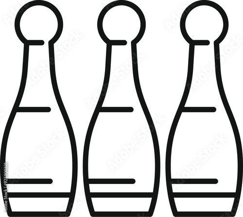 Three bowling pins are standing on a lane, waiting to be knocked down