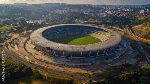 Aerial View of a Stadium in a City Surrounded by Hills and Trees