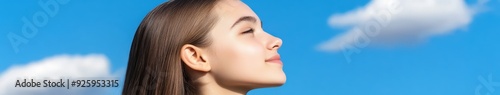 High school girl gazing up at a clear blue sky during afternoon