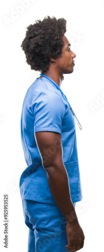 Afro american surgeon doctor man over isolated background looking to side, relax profile pose with natural face with confident smile.