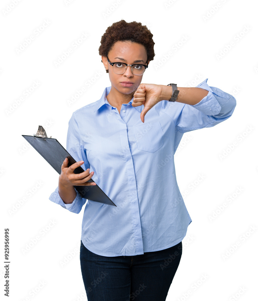 Young african american businesss woman holding clipboard over isolated background with angry face, negative sign showing dislike with thumbs down, rejection concept Young african american businesss woman holding clipboard over isolated background with angry face, negative sign showing dislike with thumbs down, rejection concept