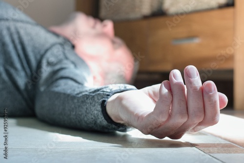 Man lying on the floor at home, epilepsy, unconsciousness, faint, stroke, accident  or other health problem