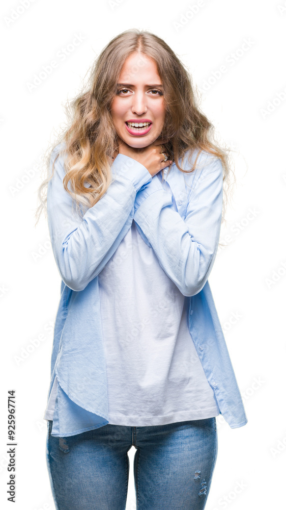 Beautiful young blonde woman over isolated background shouting and suffocate because painful strangle. Health problem. Asphyxiate and suicide concept.