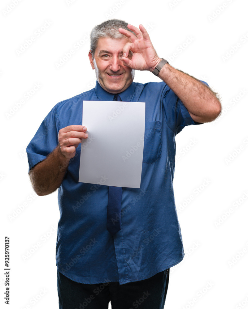 Handsome senior man holding blank sheet paper over isolated background with happy face smiling doing ok sign with hand on eye looking through fingers Handsome senior man holding blank sheet paper over isolated background with happy face smiling doing ok sign with hand on eye looking through fingers
