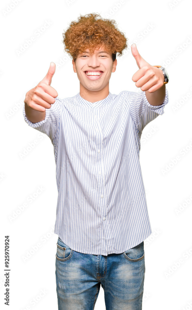 Young handsome business man with afro hair wearing elegant shirt approving doing positive gesture with hand, thumbs up smiling and happy for success. Looking at the camera, winner gesture. Young handsome business man with afro hair wearing elegant shirt approving doing positive gesture with hand, thumbs up smiling and happy for success. Looking at the camera, winner gesture.