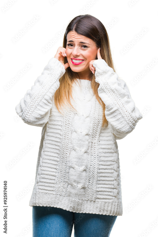 Young beautiful woman casual white sweater over isolated background covering ears with fingers with annoyed expression for the noise of loud music. Deaf concept. Young beautiful woman casual white sweater over isolated background covering ears with fingers with annoyed expression for the noise of loud music. Deaf concept.