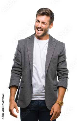 Young handsome business man over isolated background winking looking at the camera with sexy expression, cheerful and happy face.