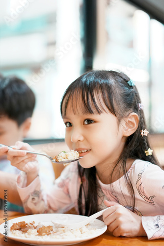Happy little boy and girl have lunch. Children eating by self. Selective focus.