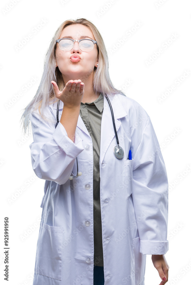 Young blonde doctor woman over isolated background looking at the camera blowing a kiss with hand on air being lovely and sexy. Love expression. Young blonde doctor woman over isolated background looking at the camera blowing a kiss with hand on air being lovely and sexy. Love expression.