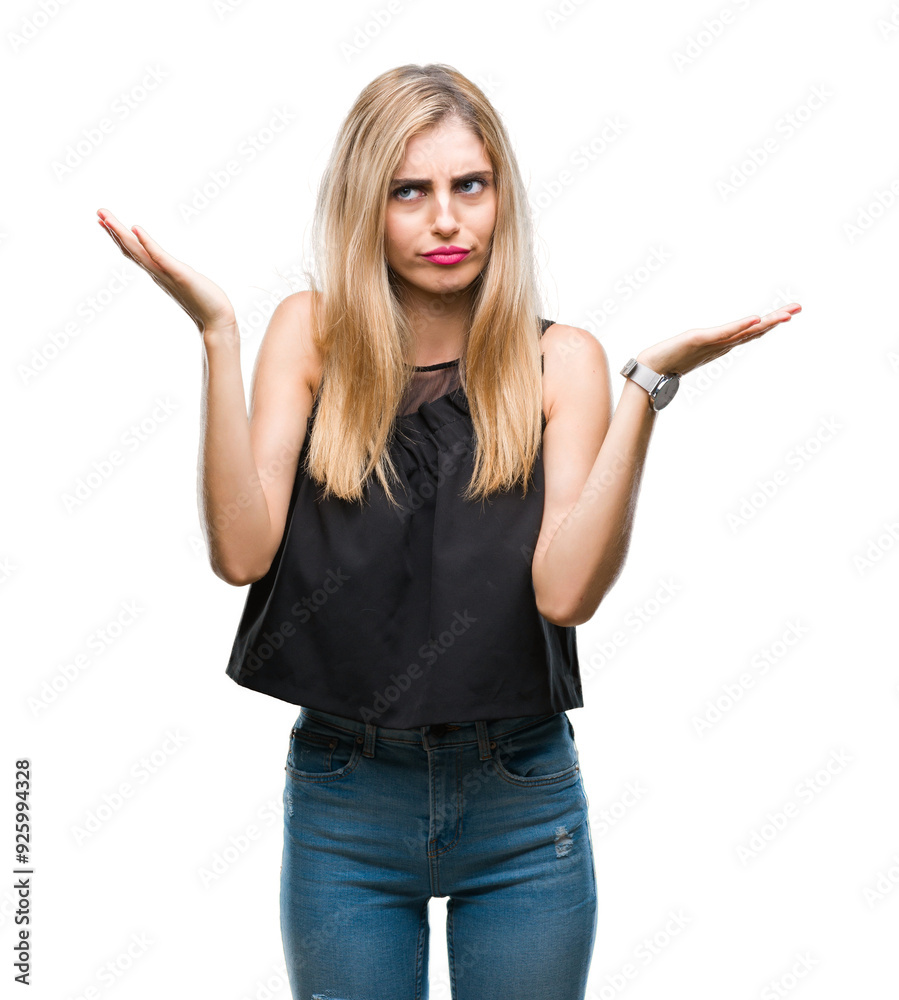 Young beautiful blonde and blue eyes woman over isolated background clueless and confused expression with arms and hands raised. Doubt concept. Young beautiful blonde and blue eyes woman over isolated background clueless and confused expression with arms and hands raised. Doubt concept.