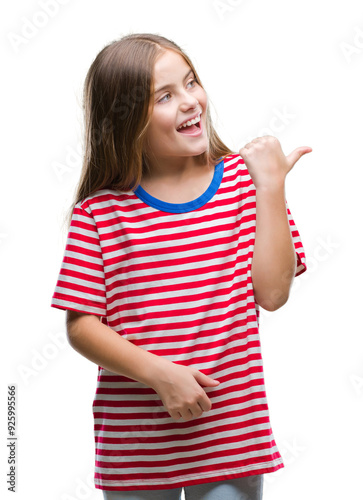 Young beautiful girl over isolated background smiling with happy face looking and pointing to the side with thumb up.