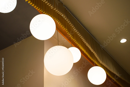 Group set of lamps interior with a brown wall in the modern house style, View of a modern beautiful ceiling light. The minimalist interior is decorated with circular light bulbs in warm tones 2024.
