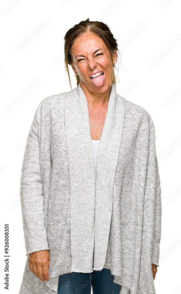 Beautiful middle age adult woman wearing winter sweater over isolated background sticking tongue out happy with funny expression. Emotion concept. Beautiful middle age adult woman wearing winter sweater over isolated background sticking tongue out happy with funny expression. Emotion concept.