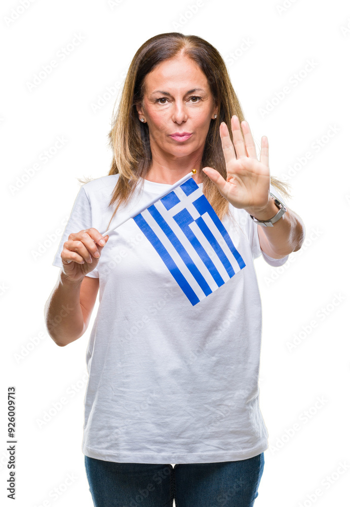 Middle age hispanic woman holding flag of Greece over isolated background with open hand doing stop sign with serious and confident expression, defense gesture Middle age hispanic woman holding flag of Greece over isolated background with open hand doing stop sign with serious and confident expression, defense gesture