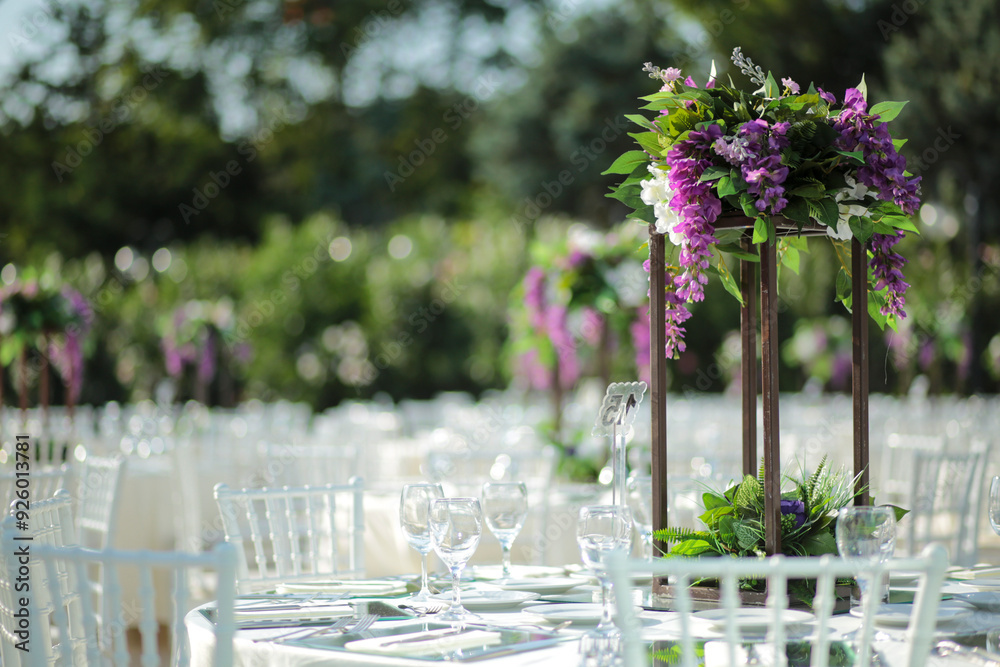 Garden Wedding Setup: Round Tables with Purple and White Floral Decor