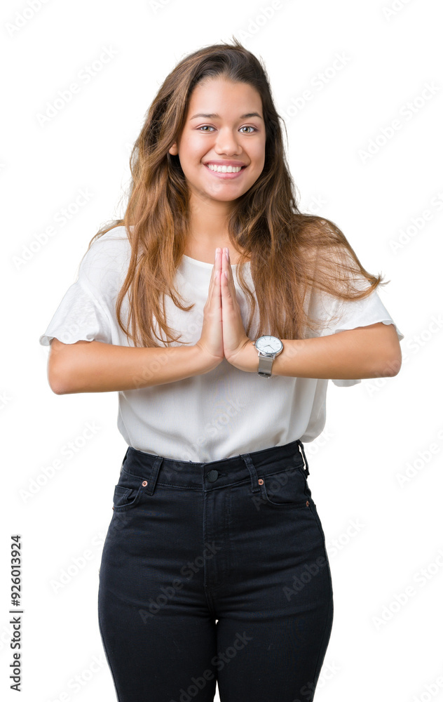 Young beautiful brunette business woman over isolated background praying with hands together asking for forgiveness smiling confident. Young beautiful brunette business woman over isolated background praying with hands together asking for forgiveness smiling confident.