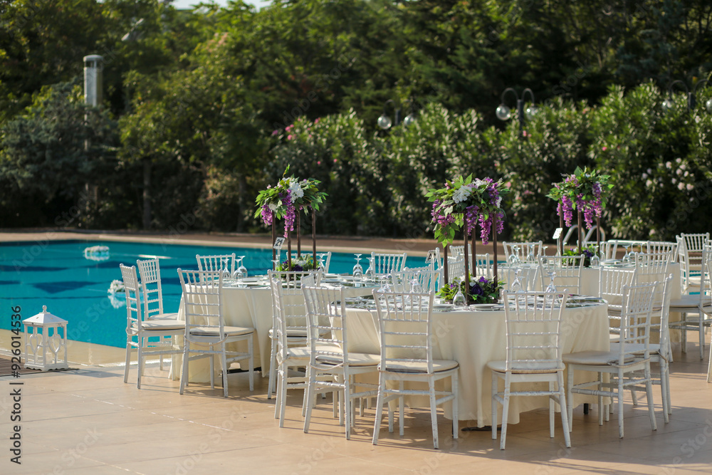 Garden Wedding Setup: Round Tables with Purple and White Floral Decor