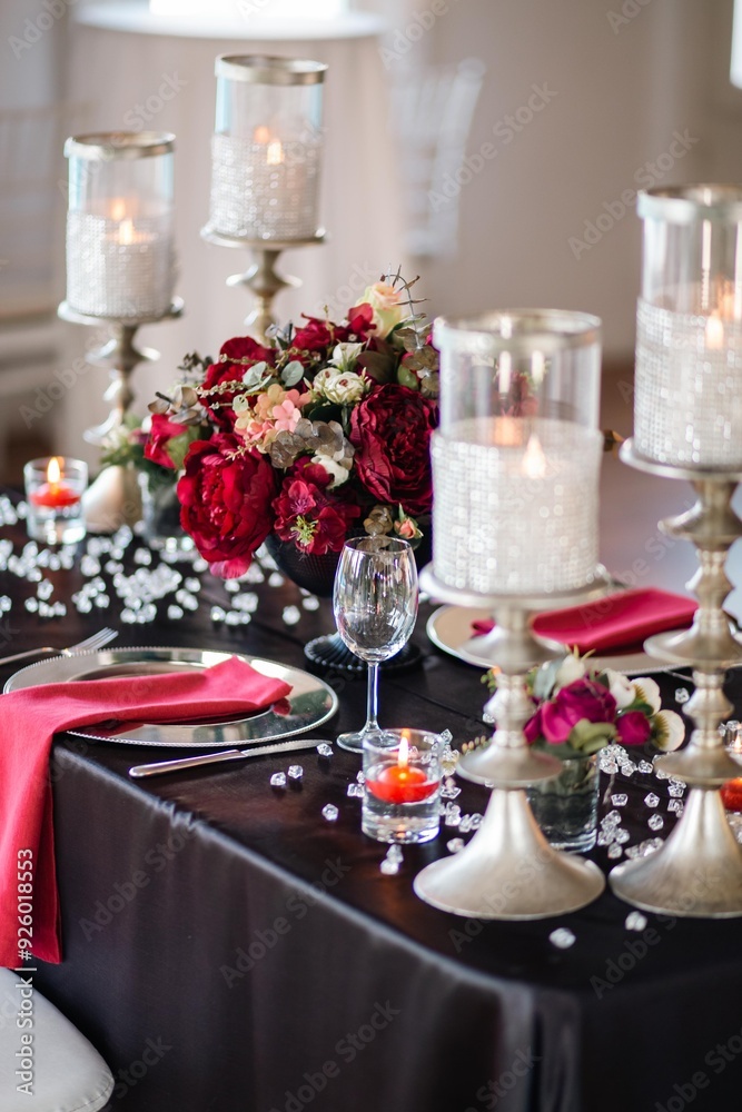 Elegant Table Setting with Silver Candle Holders and Dark Accents