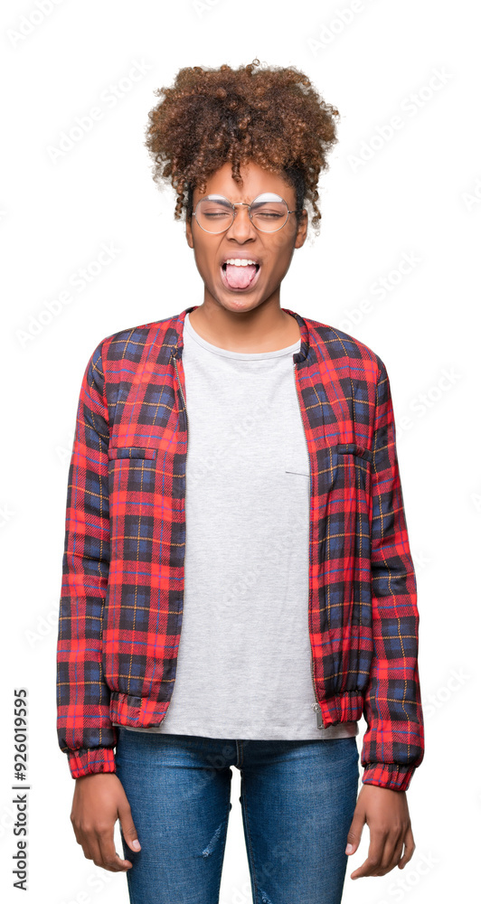 Beautiful young african american woman wearing glasses over isolated background sticking tongue out happy with funny expression. Emotion concept. Beautiful young african american woman wearing glasses over isolated background sticking tongue out happy with funny expression. Emotion concept.