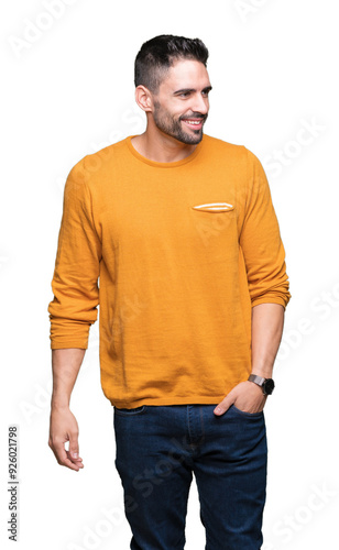 Young handsome man over isolated background looking away to side with smile on face, natural expression. Laughing confident.