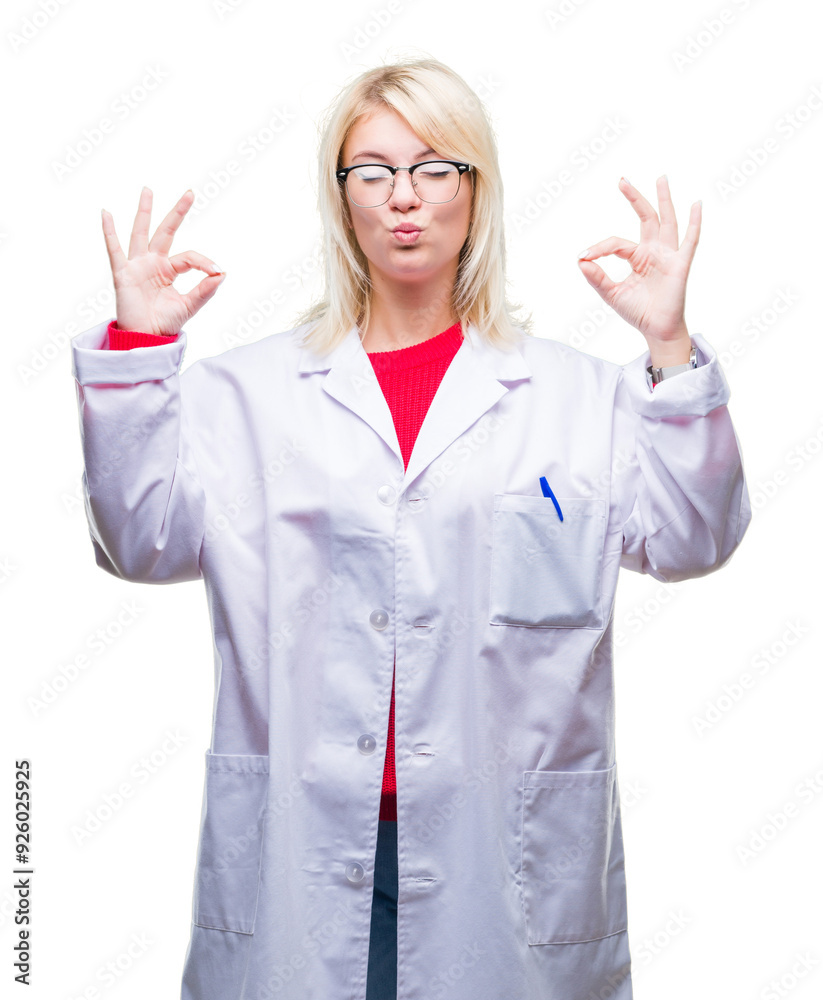 Young beautiful blonde professional woman wearing white coat over isolated background relax and smiling with eyes closed doing meditation gesture with fingers. Yoga concept. Young beautiful blonde professional woman wearing white coat over isolated background relax and smiling with eyes closed doing meditation gesture with fingers. Yoga concept.