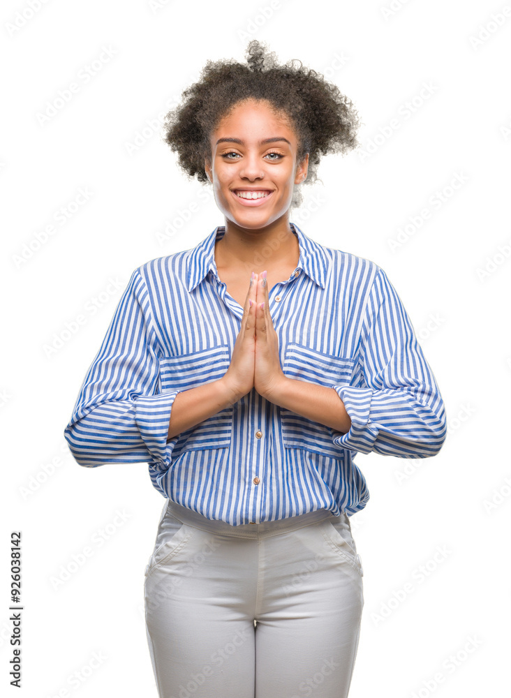 Young afro american woman over isolated background praying with hands together asking for forgiveness smiling confident. Young afro american woman over isolated background praying with hands together asking for forgiveness smiling confident.