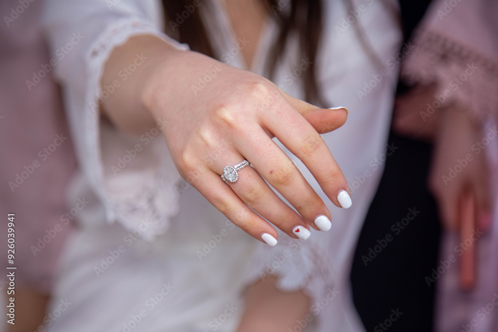 ride showing her hand with a diamond engagement ring and white manicure. A perfect moment capturing elegance, love, and commitment, ideal for wedding photography or bridal-themed visuals