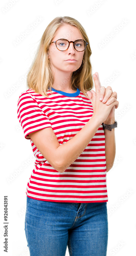Beautiful young woman wearing glasses over isolated background Holding symbolic gun with hand gesture, playing killing shooting weapons, angry face Beautiful young woman wearing glasses over isolated background Holding symbolic gun with hand gesture, playing killing shooting weapons, angry face