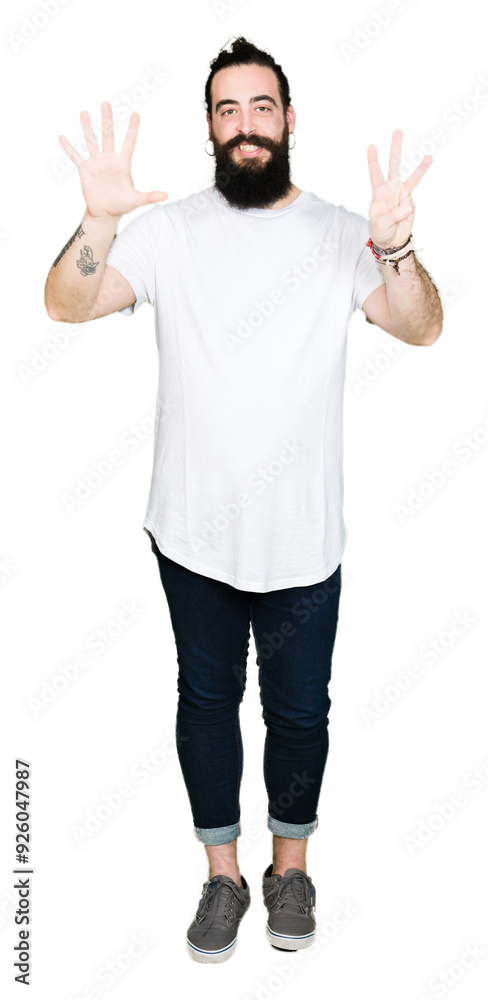 Young hipster man with long hair and beard wearing casual white t-shirt showing and pointing up with fingers number eight while smiling confident and happy.