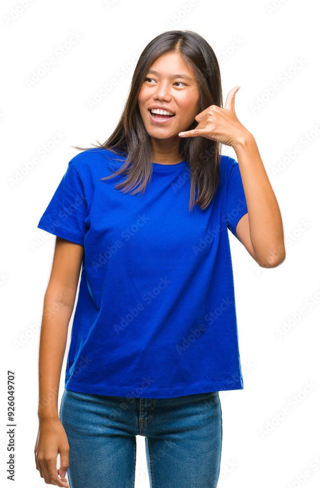 Young asian woman over isolated background smiling doing phone gesture with hand and fingers like talking on the telephone. Communicating concepts. Young asian woman over isolated background smiling doing phone gesture with hand and fingers like talking on the telephone. Communicating concepts.
