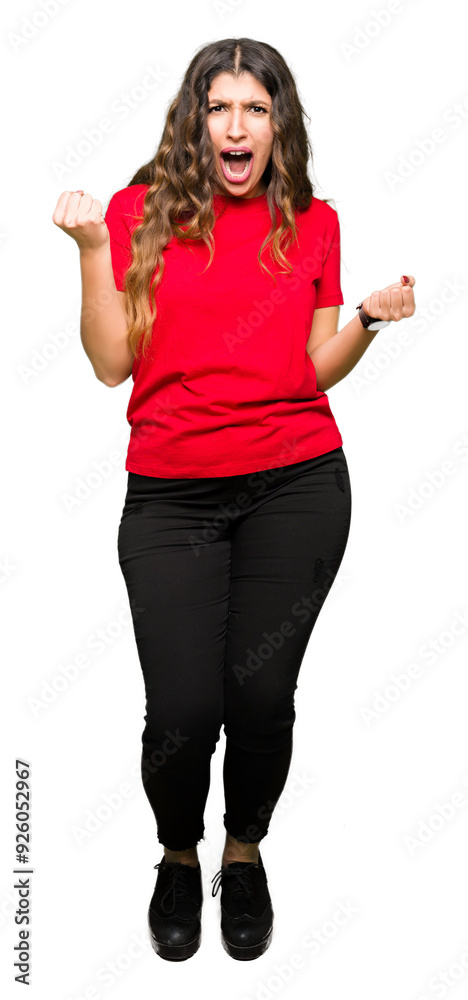 Young beautiful woman wearing casual t-shirt celebrating surprised and amazed for success with arms raised and open eyes. Winner concept.