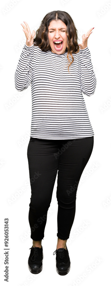 Fototapeta premium Young beautiful woman wearing stripes sweater celebrating crazy and amazed for success with arms raised and open eyes screaming excited. Winner concept