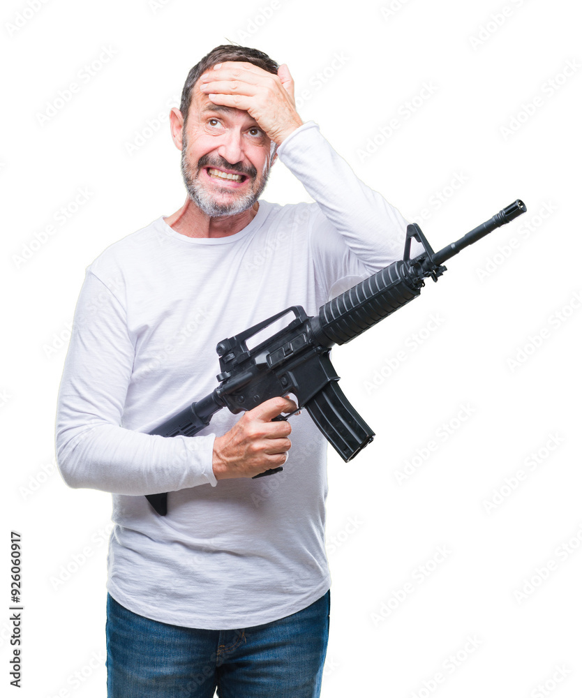 Middle age senior hoary criminal man holding gun weapon over isolated background stressed with hand on head, shocked with shame and surprise face, angry and frustrated. Fear and upset for mistake. Middle age senior hoary criminal man holding gun weapon over isolated background stressed with hand on head, shocked with shame and surprise face, angry and frustrated. Fear and upset for mistake.