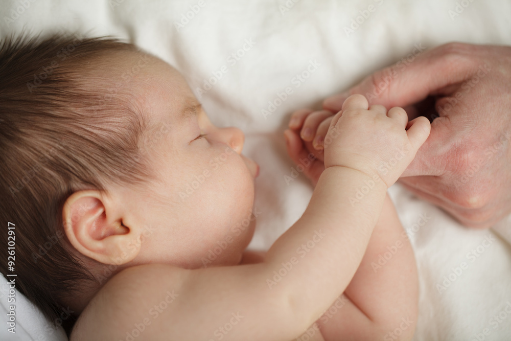 Childhood, love, safety, family and baby protection concept. Newborn baby with daddy's hand. Childhood, love, safety, family and baby protection concept. Newborn baby with daddy's hand.