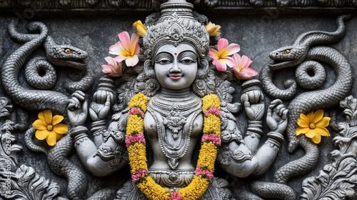 Hindu Goddess Sculpture with Snakes and Flowers - A detailed carving of a Hindu goddess with snakes and flowers, symbolizing spirituality, power, protection, beauty, and nature. photo