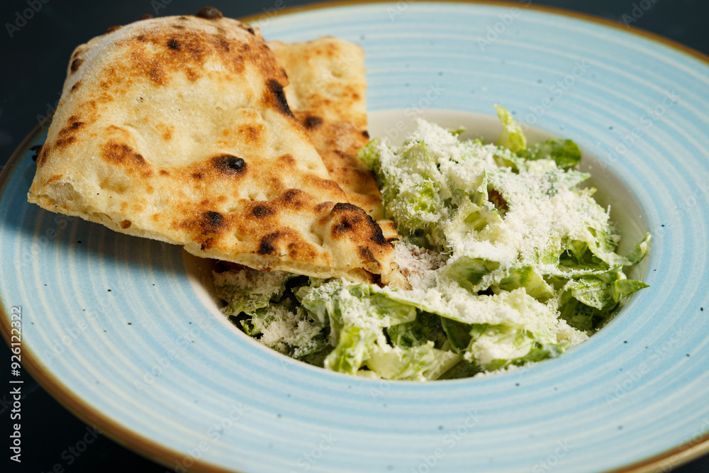 Caesar salad with fried chicken slices, tomato, parmesan cheese, tomato and crispy focaccia Caesar salad with fried chicken slices, tomato, parmesan cheese, tomato and crispy focaccia