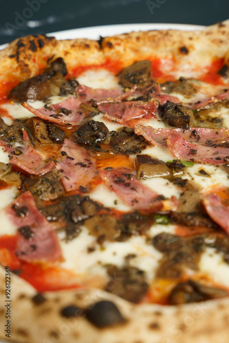 Close up of Original Italian pizza with tomato sauce and ham