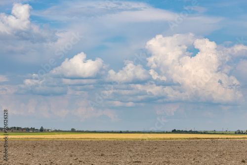 Fototapeta Naklejka Na Ścianę i Meble -  A cloudy sky with a few clouds in the distance